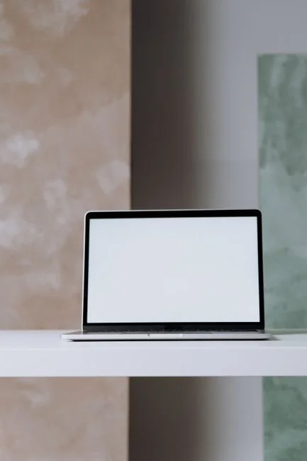 Portable computer with website representing assorted abstract photos under favorites and browser search engine with magnifier symbol